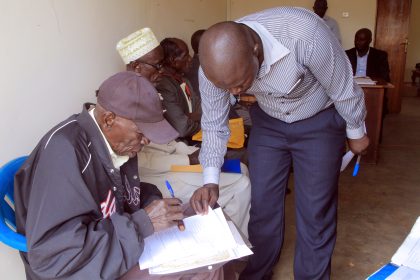 Yumbe district HRO assist pensioners while filling in the required form before validation is done